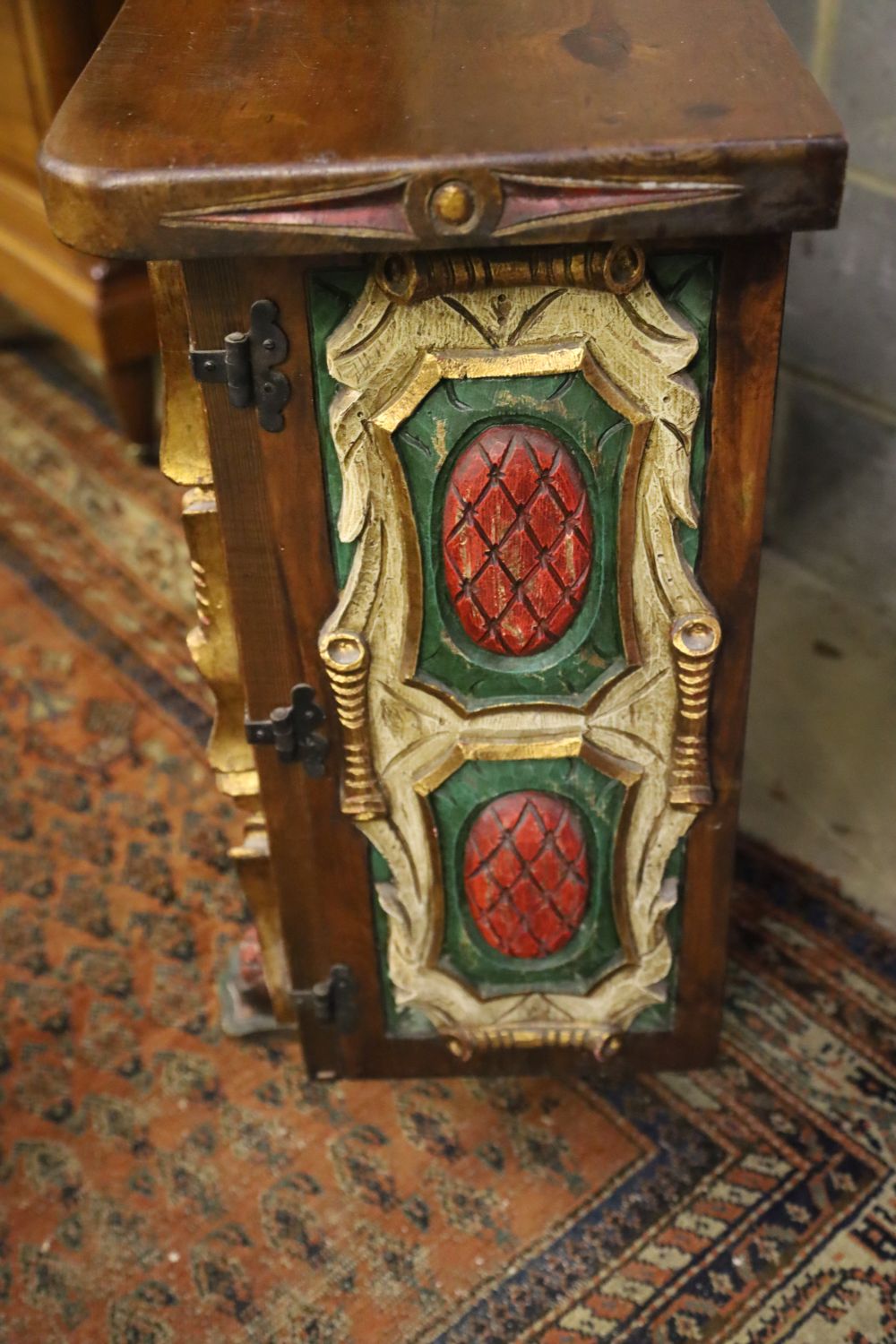 A Spanish carved, painted two door side cabinet, width 118cm, depth 34cm, height 80cm